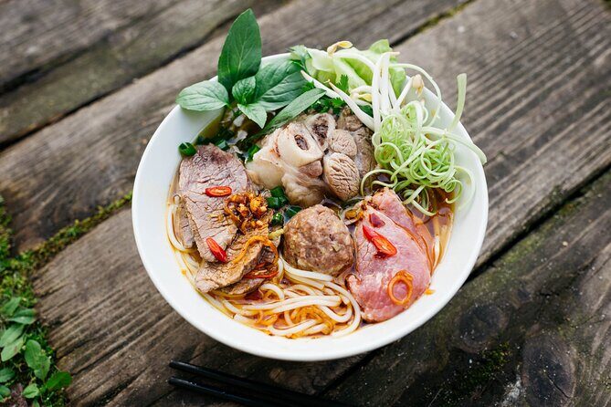 12 Tasting Street Food & Sightseeing By Scooter with Student - A 4-hour scooter loop that mixes eats with real streets