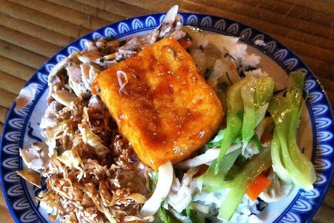 Private Vegan Food Tour in Ho Chi Minh City By Motorbike - Nguyen Thien Thuat apartment buildings and a pagoda pause