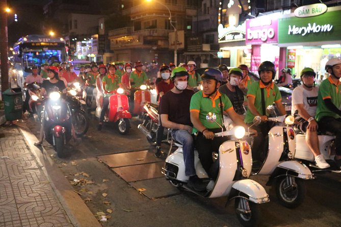 Saigon Vespa By Night Street Food Tour 4,5 Hours - Stop 1 at Ho Chi Minh Square: Watching Saigon Move