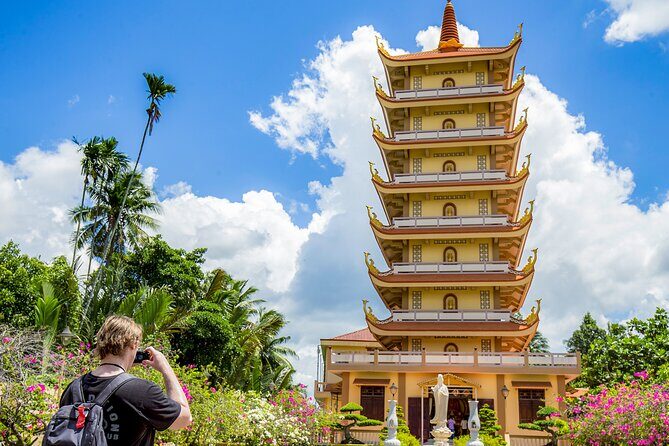 Small-Group Mekong Delta Day Trip: Boat Ride, Cottages & Pagoda - Motorboat canals and Rạch Miễu Bridge photo time